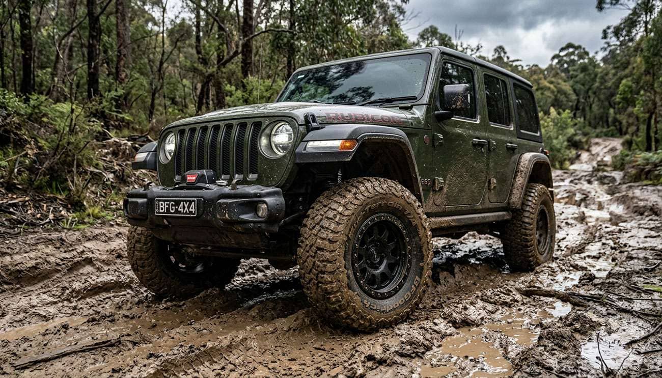 BFGoodrich Mud-Terrain T/A KM3 tires mounted on a Jeep Wrangler on a muddy trail