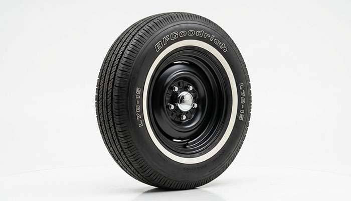 American Classic bias-look radial tire with tall sidewall shown on a clean white studio backdrop