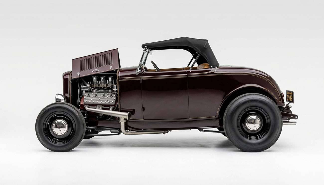 Traditional 1932-style hot rod roadster with skinny front tires and fat rear tires showing classic big and little rake on a clean white seamless backdrop