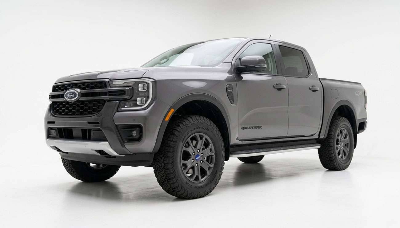 Ford Ranger pickup on factory wheels with upsized all-terrain tires showing front wheel well clearance