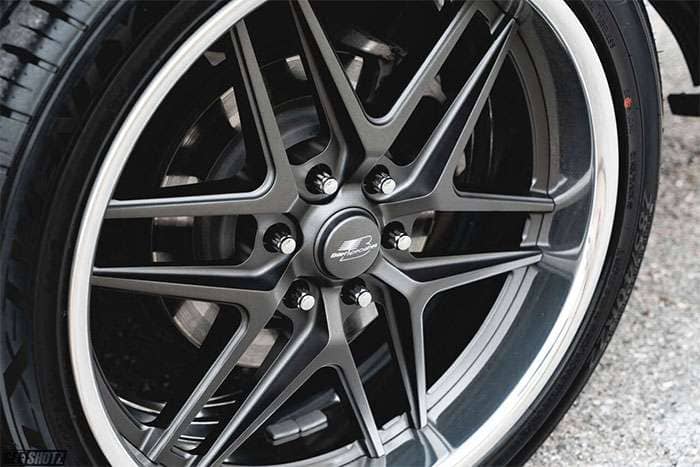 Close-up of a gunmetal Billet Specialties Tec 6 wheel, 22x10 size with 6x135 bolt pattern and polished lip