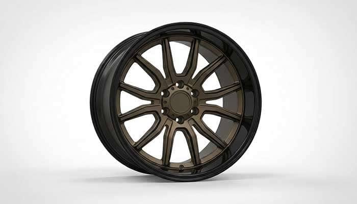 Close-up of stylish bronze and black truck wheels with multi-spoke design displayed indoors