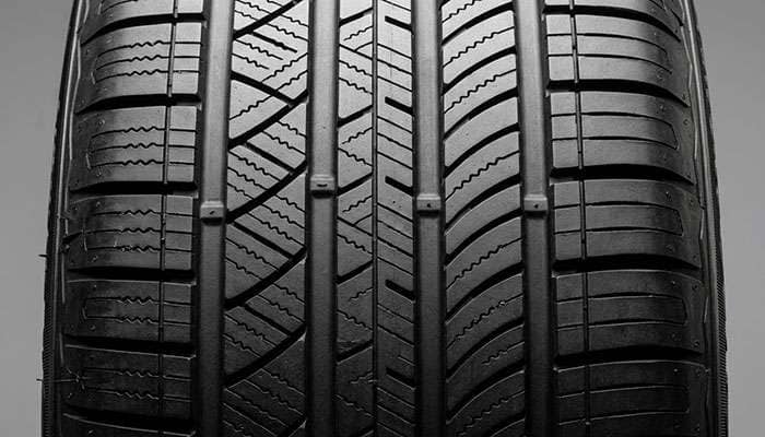 Macro close-up of budget-tier all-season tire tread pattern