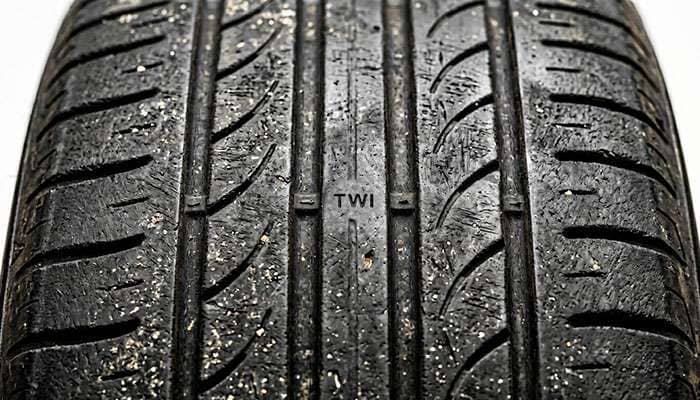 Budget tire tread with wear bar near 2/32 inch
