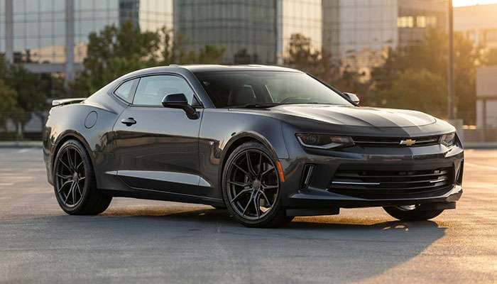 Dark gray Chevrolet 6th Gen Camaro parked outdoors showcasing aftermarket multi-spoke wheels and tires