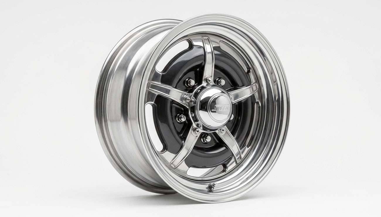 Polished steel wheel dressed with a chrome trim ring and a center cap on a clean white studio background