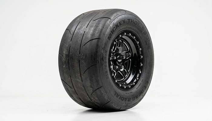 Drag cheater slick tire showing minimal shallow tread grooves