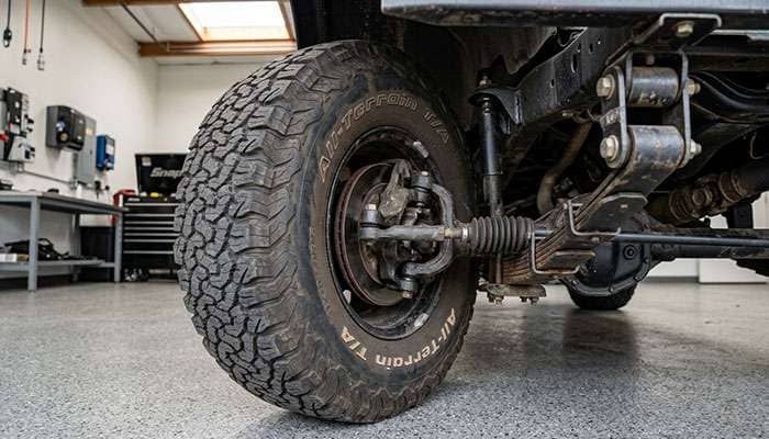 CJ-7 front tire turned to full lock showing clearance between the tire sidewall and the front leaf spring