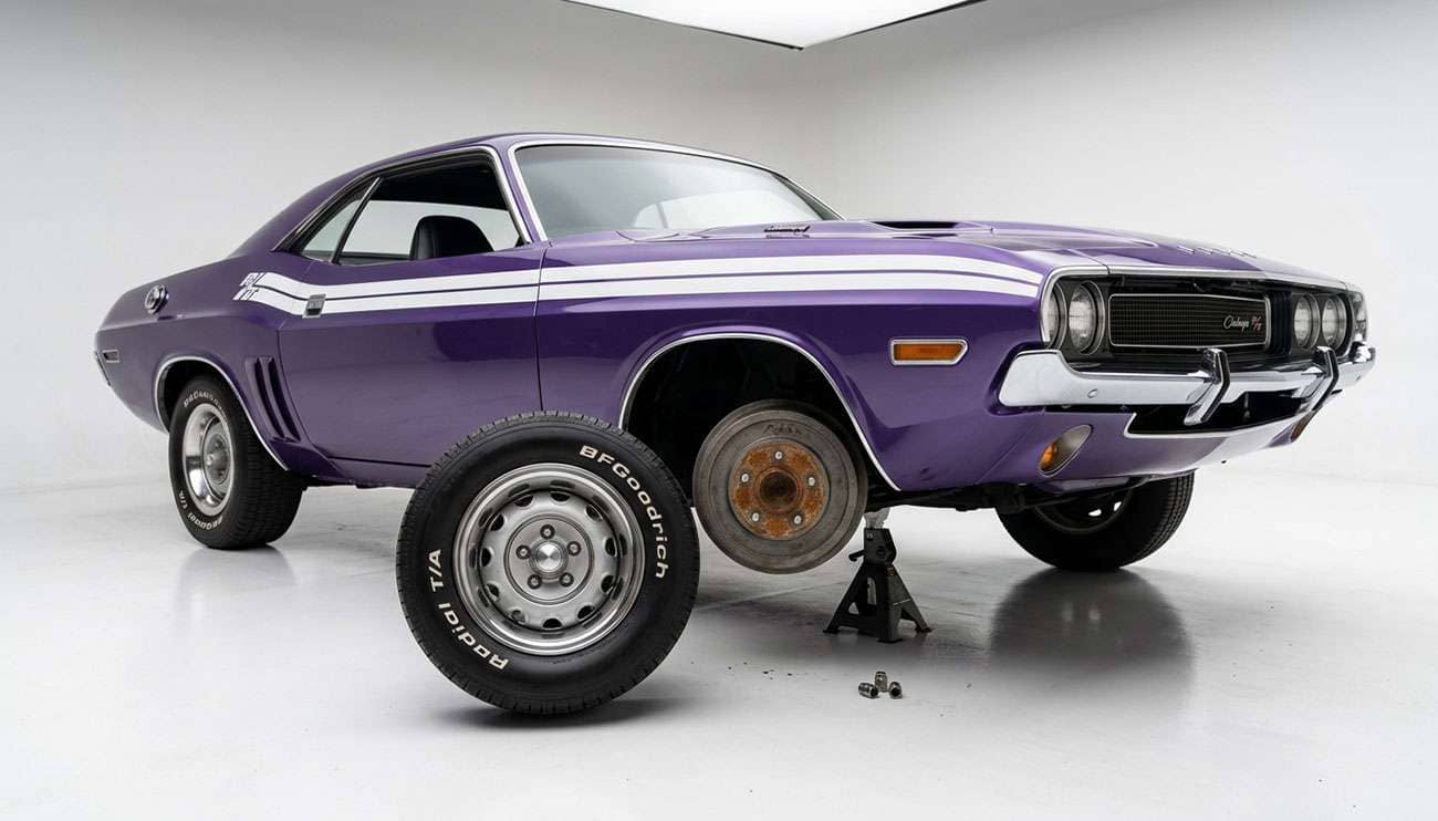 Classic muscle car with front wheel removed showing rust corrosion ring on the hub face