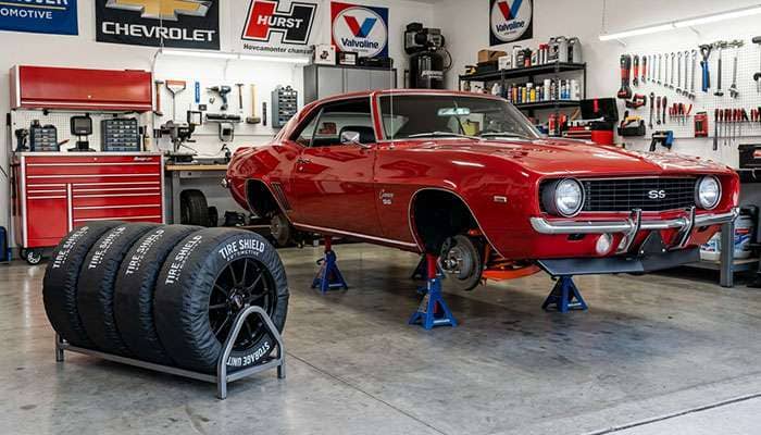 classic car on jack stands with tires properly stored showing correct positioning to prevent dry rot and flat spotting