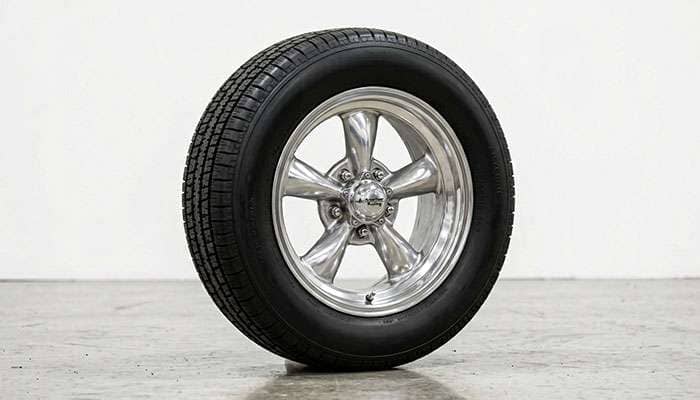 Classic five-spoke mag wheel in a period-correct hot rod style