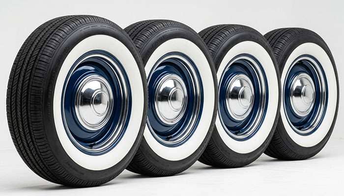Set of wide whitewall radial tires on 15-inch steel wheels for a classic car
