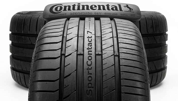Overhead close-up of Continental SportContact 7 tread pattern showing asymmetric tread blocks and circumferential grooves