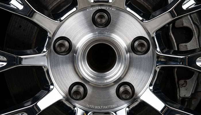 Close-up of a Corvette wheel featuring a 5x120 bolt pattern setup on the rim hub area