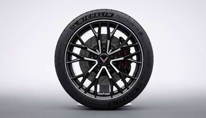 Close-up of a Corvette wheel featuring a 5x120 bolt pattern setup on a sleek tire rim.
