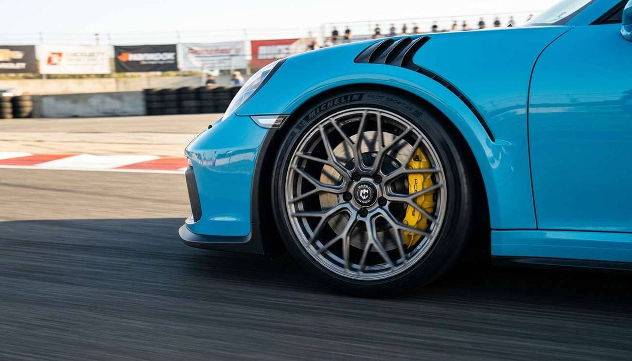 Curva CFF flow-forged performance wheel on a white studio backdrop, three-quarter angle showing concave split-spoke face