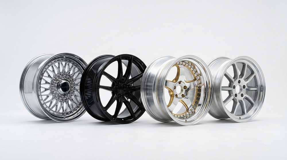 Four different styles of car alloy wheels displayed in a workshop setting for a wheel guide