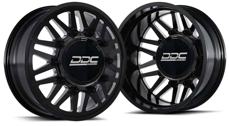 Pair of black Dually Design Co (DDC) wheels with multi-spoke design and central DDC logo caps