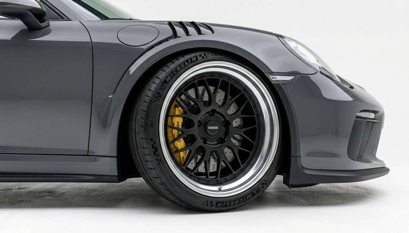Deep dish rim with a wide polished lip mounted on a performance car