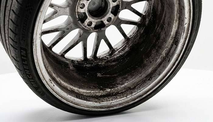 Recessed barrel of a deep dish wheel showing brake dust and grime buildup on the inner lip