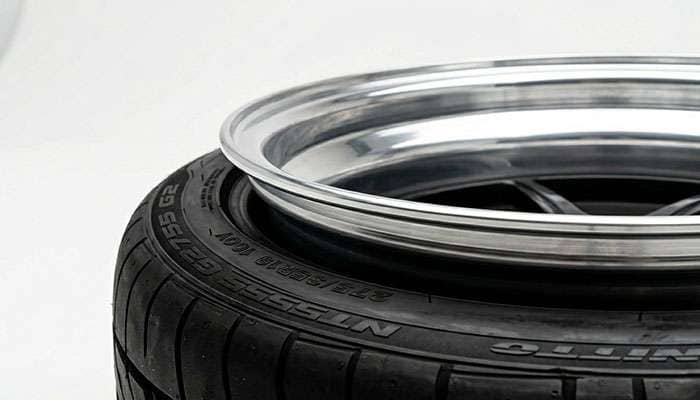 Close-up of a deep dish wheel outer lip showing exposure beyond the tire sidewall