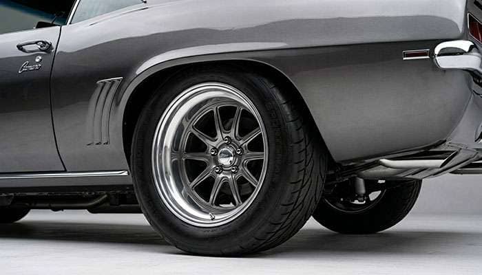 Deep dish wheel mounted on a classic car showing wide rear tire fitment and aggressive lip stance