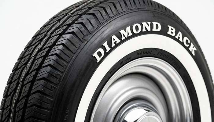 Close-up of a Diamond Back radial tire sidewall showing the molded-in whitewall band