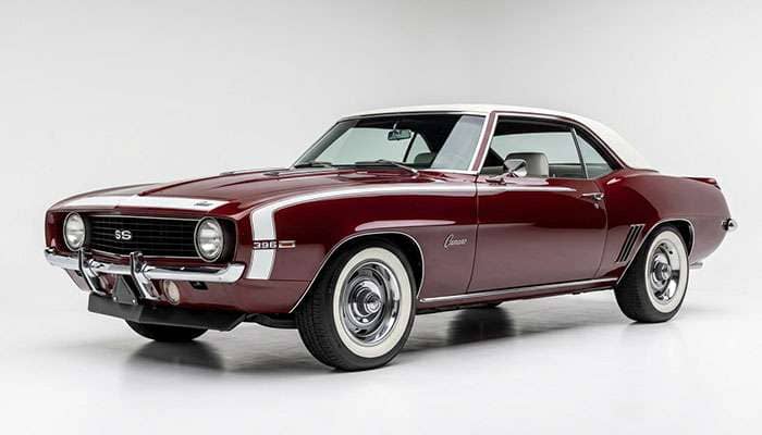 Restored muscle car fitted with Diamond Back whitewall radial tires at a car show