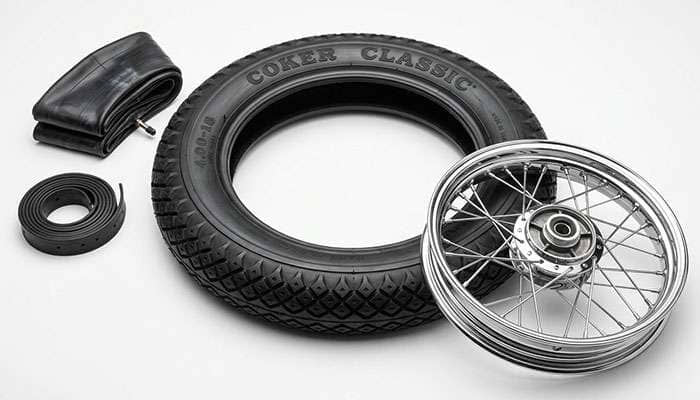 Coker Classic Motorcycle Diamond Tread 4.00-18 tire with raised COKER lettering beside a new inner tube, rubber rim strip, and spoked 18-inch motorcycle rim