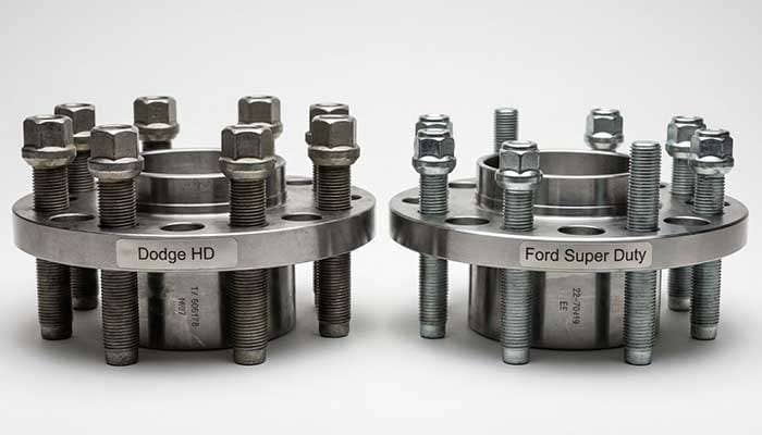Close-up comparison of Dodge and Ford wheel threads highlighting the differences in thread patterns and size