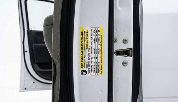 Tire and loading information placard on a pickup truck's driver door jamb
