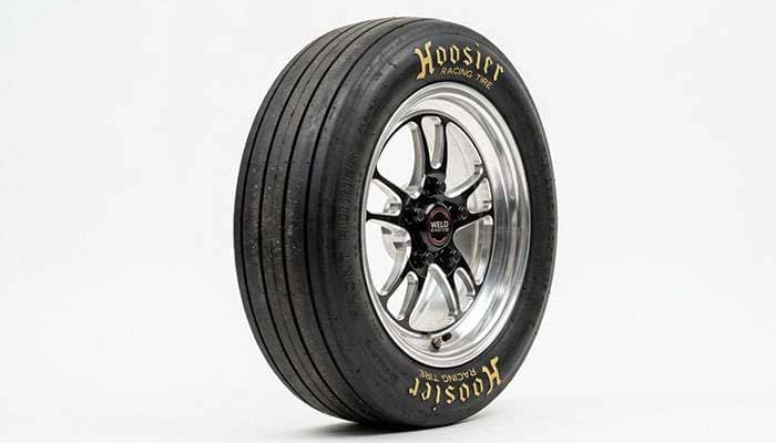 Close-up of a skinny drag racing front runner tire showing the narrow profile and lightweight construction designed to reduce rotating mass