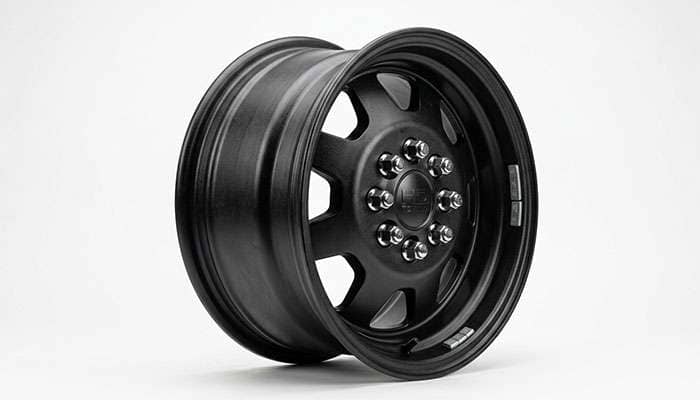 Heavy-duty dually truck wheel for towing applications on a clean white studio backdrop