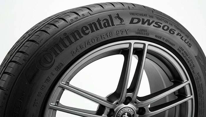 Continental DWS06 Plus tire sidewall showing size and speed rating markings on a clean studio backdrop