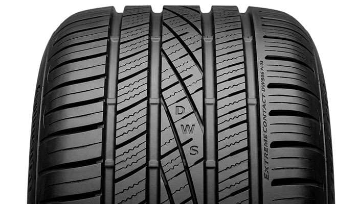 Continental DWS06 Plus tread pattern showing wet-weather water evacuation grooves on a clean studio backdrop