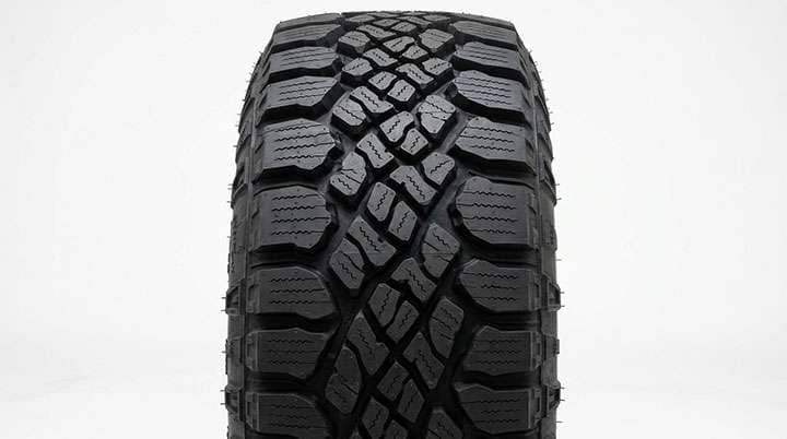 Close-up of Hankook Dynapro AT2 tread showing multi-directional grooves sipes and locking shoulder lugs
