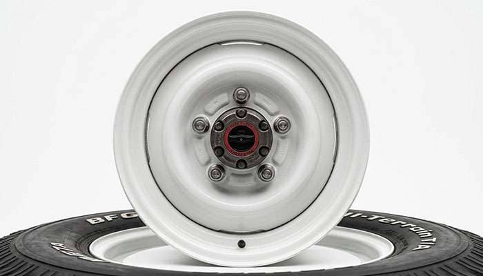 Close-up of an early Bronco wheel showing the 5 on 5.5 inch five-lug bolt pattern