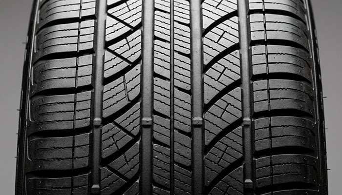 EV tire tread pattern detail showing closed shoulder design and low rolling resistance geometry