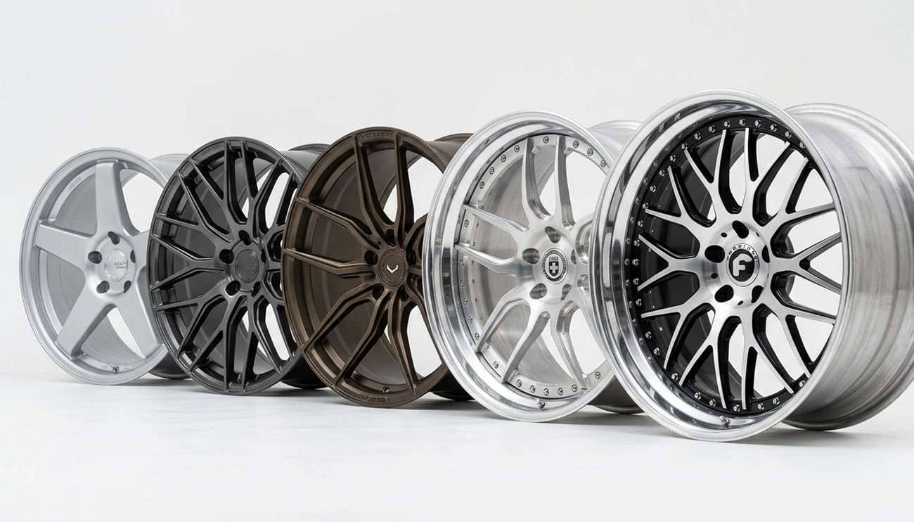 Row of premium forged aftermarket wheels displayed on a clean white background showing cast, forged, and three-piece construction