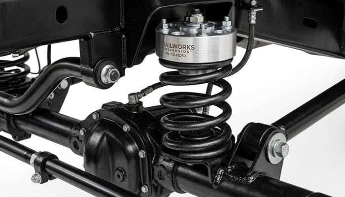Front coil spring leveling spacer installed on a heavy-duty truck solid front axle