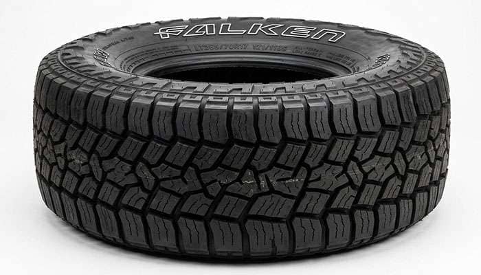 Close-up of Falken Wildpeak A/T4W tread blocks showing full-depth sipes and stone ejectors