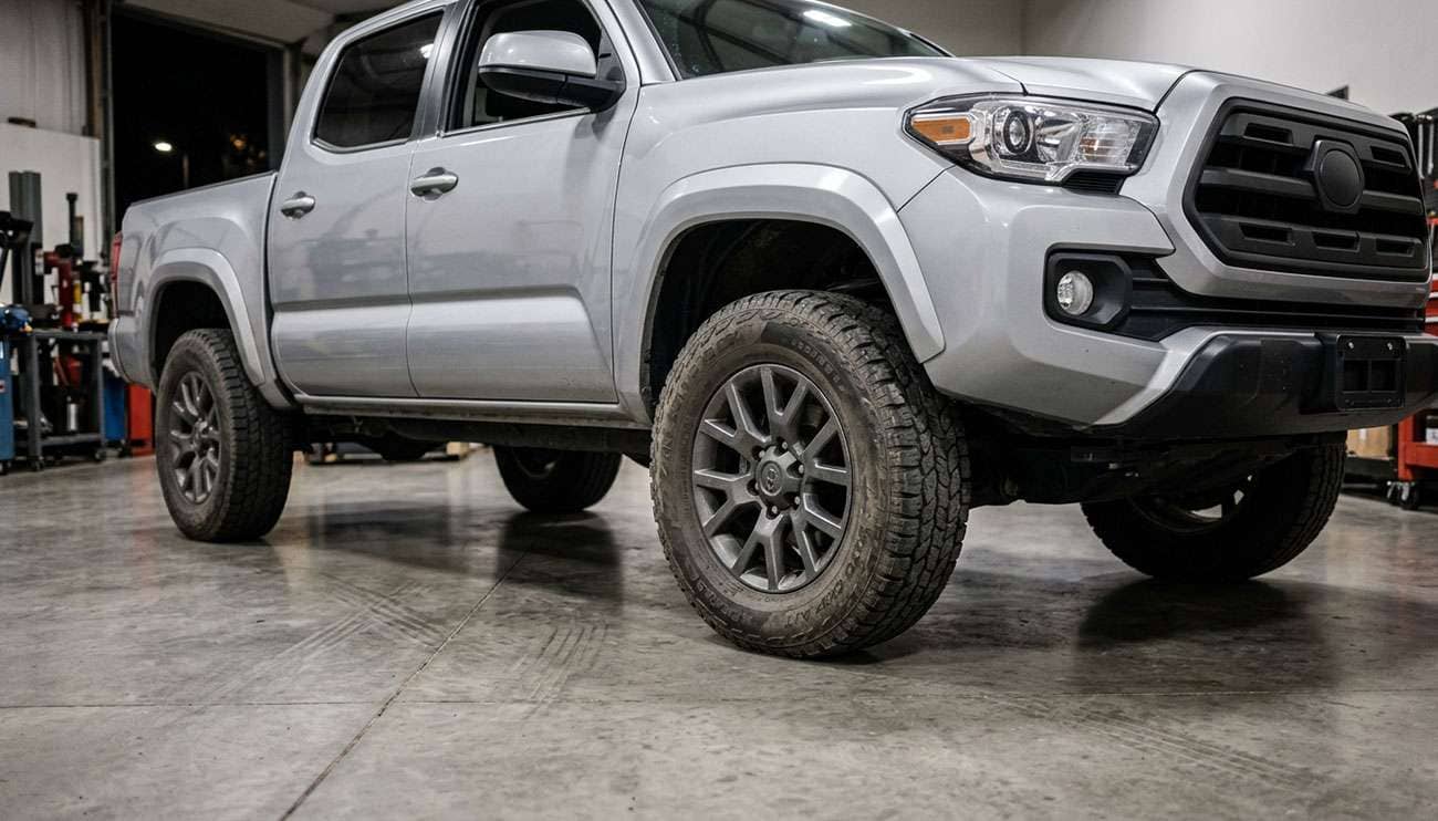 Vehicle with worn Firestone tires after long-term real-world testing showing tread condition