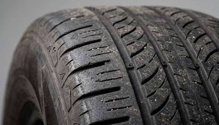 Tread wear pattern on Firestone tire at 30000 miles showing wear bar progression