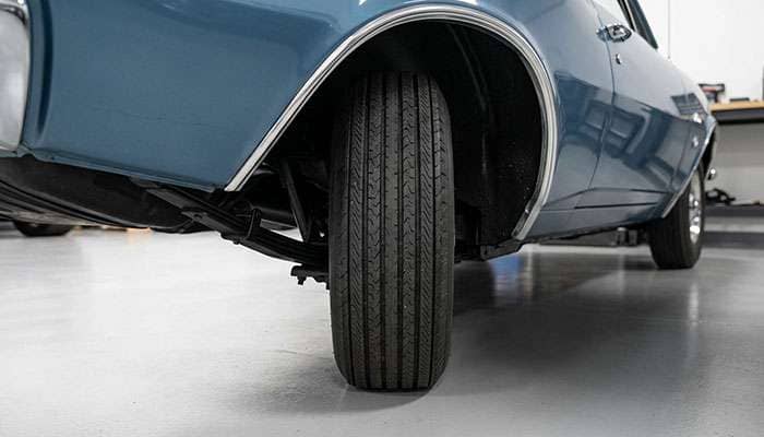 Rear wheelhouse of a 1967-69 Camaro showing tire clearance between the leaf spring and the quarter panel lip