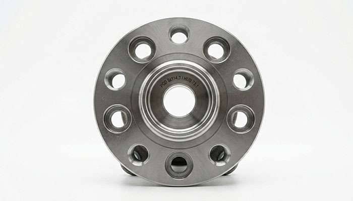 Close-up of a five-lug wheel hub showing the bolt pattern on a white studio backdrop
