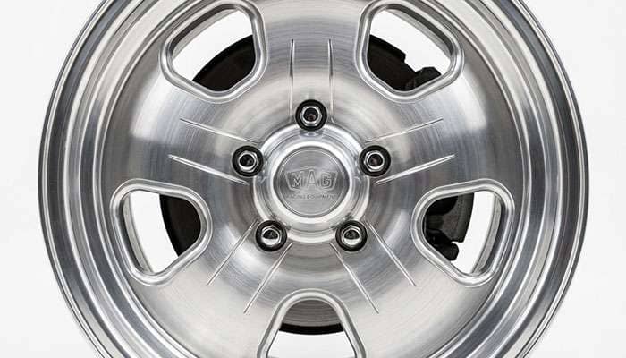 Close-up of a five-slot mag wheel face showing the slotted openings and polished finish