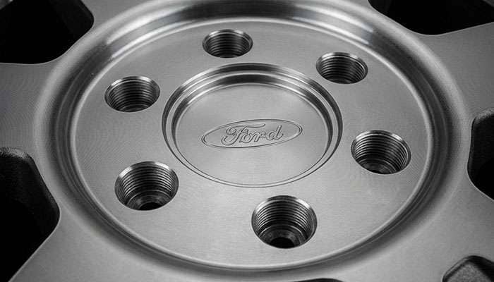 Close-up view of Ford truck hub showing 6x135mm bolt pattern with six lug holes