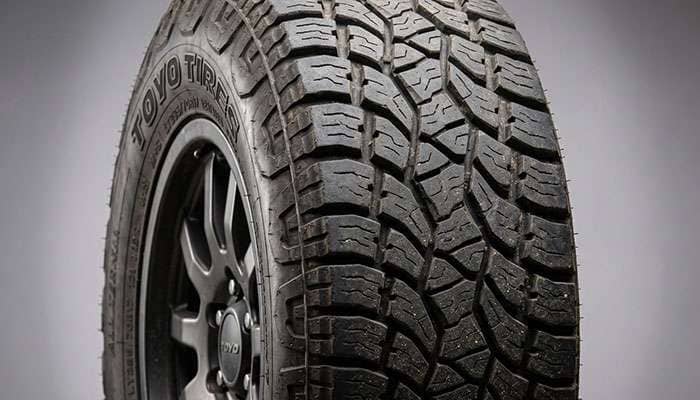 Close-up of a rugged Ford Explorer Sport Trac truck tire with deep aggressive tread pattern