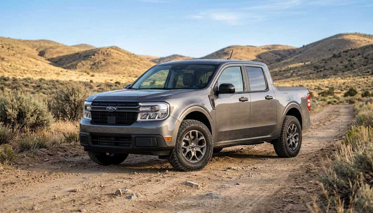 Ford Maverick compact pickup on upsized all-terrain tires parked on a dirt road