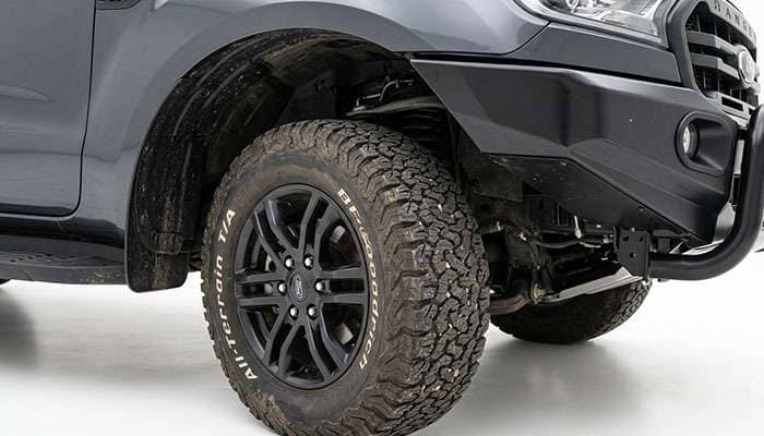 Ford Ranger front wheel turned to full lock showing tire clearance to the front crash bar and wheel well liner